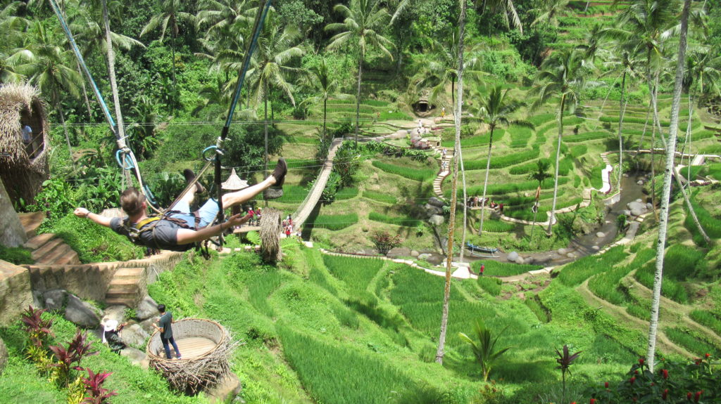 Young Alcoholic on a swing in Bali, Indonesia