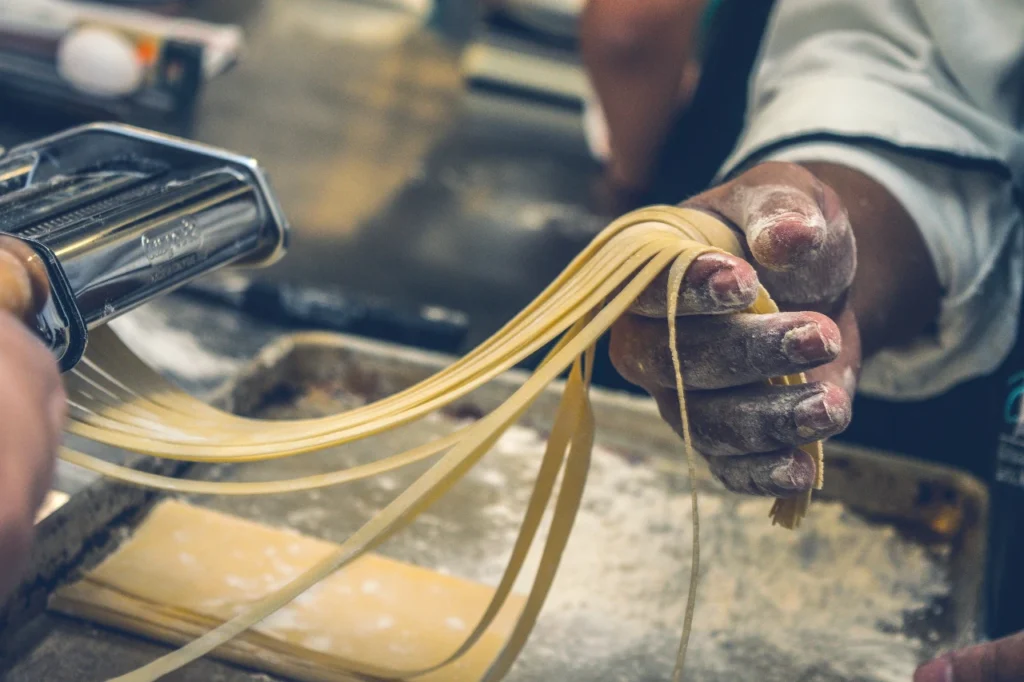 Man making fresh pasta as a sober activity